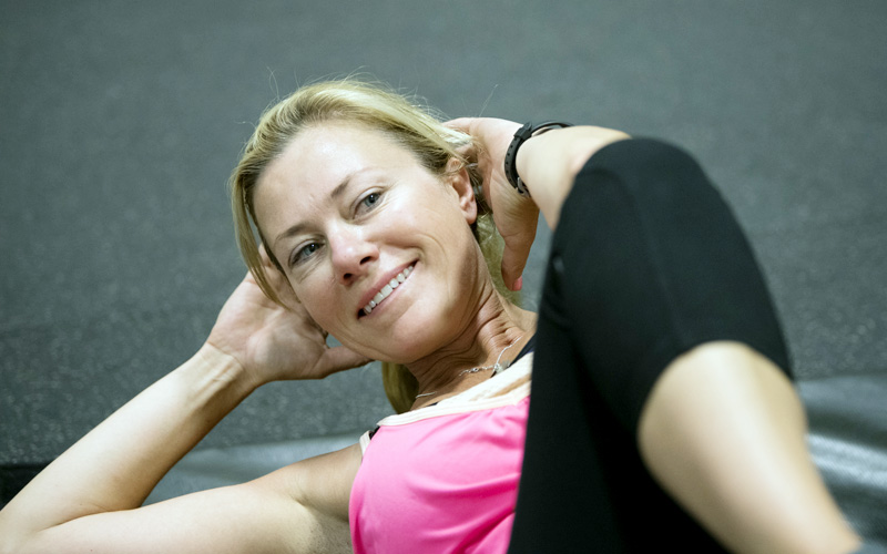 Smiling woman doing stretches