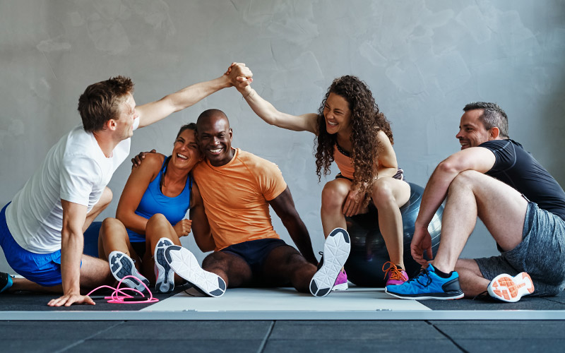Group of people sitting, having fun at gym